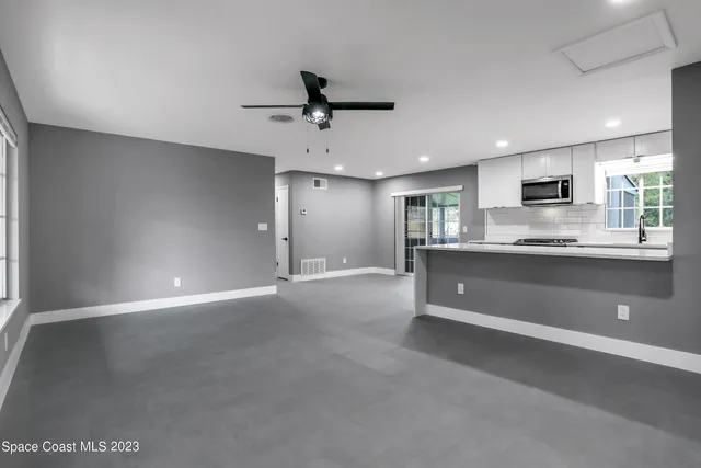a view of kitchen with refrigerator and window