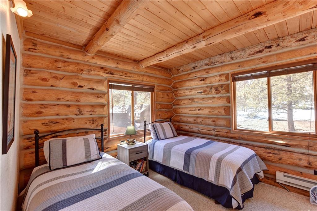2206 Campfire Road Hartsel, CO 80449 - Photo 14 of 35 a bedroom with a bed and wooden floor