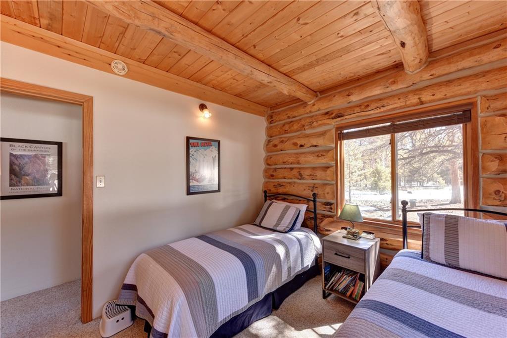 2206 Campfire Road Hartsel, CO 80449 - Photo 15 of 35 a bedroom with a bed and wooden floor