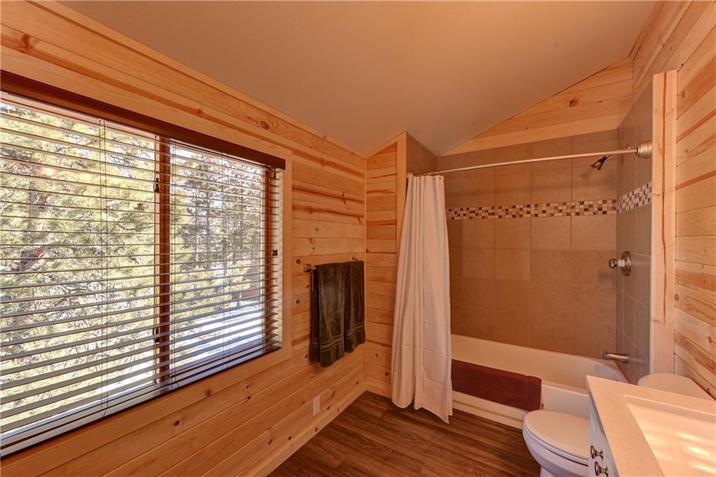 2206 Campfire Road Hartsel, CO 80449 - Photo 20 of 35 a view of a bedroom with wooden floor and furniture