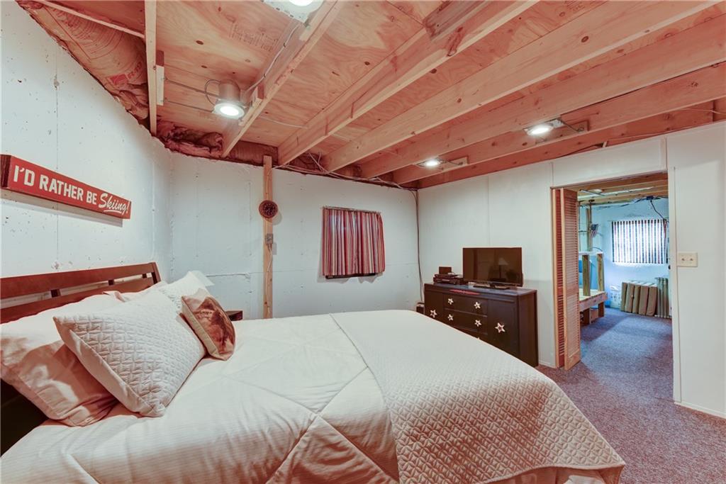 2206 Campfire Road Hartsel, CO 80449 - Photo 25 of 35 a bedroom with a bed and a large mirror