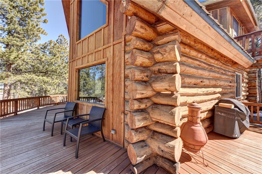 2206 Campfire Road Hartsel, CO 80449 - Photo 27 of 35 a view of a roof deck with table and chairs with wooden floor and fence