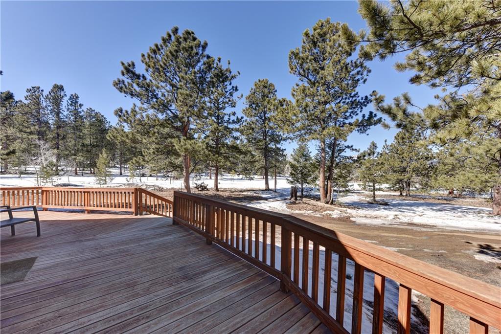2206 Campfire Road Hartsel, CO 80449 - Photo 32 of 35 a view of a balcony with wooden floor and fence