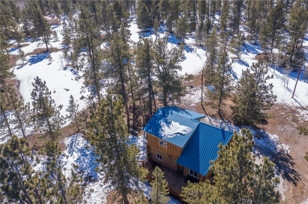 2206 Campfire Road Hartsel, CO 80449 - Photo 35 of 35 a view of a house with a yard and covered with snow