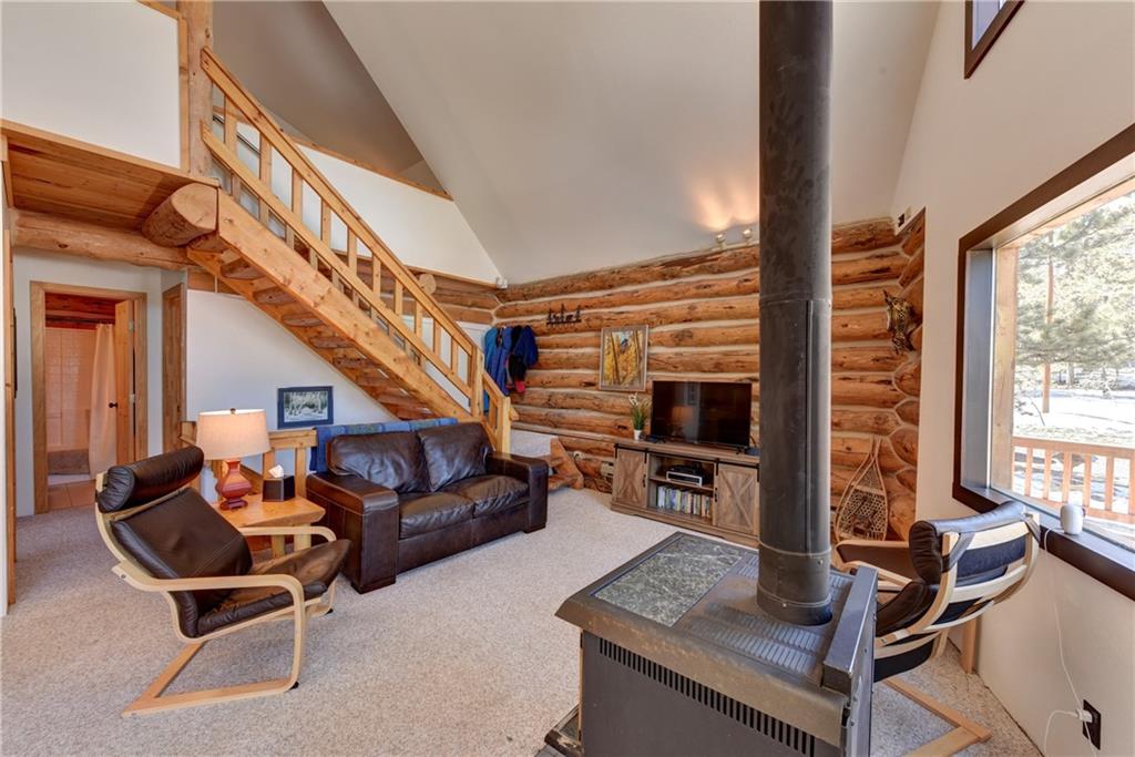 2206 Campfire Road Hartsel, CO 80449 - Photo 6 of 35 a living room with furniture a flat screen tv and a large window