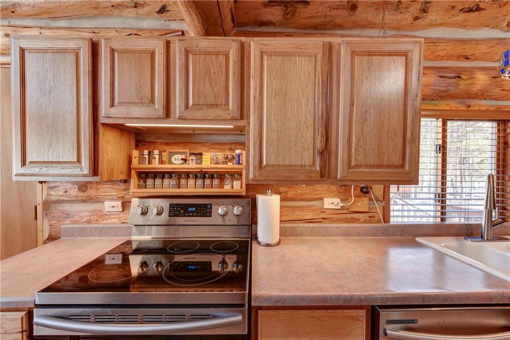 2206 Campfire Road Hartsel, CO 80449 - Photo 10 of 35 a kitchen with granite countertop a stove and a sink