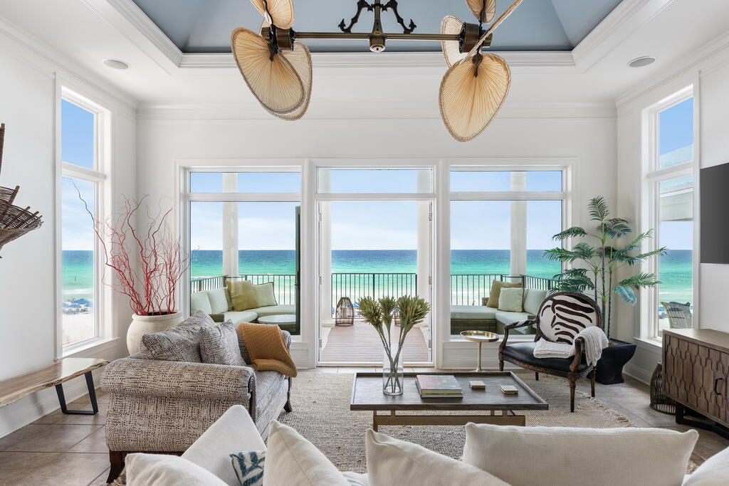 4748 Ocean Boulevard Destin, FL 32541 - Photo 2 of 80 a living room with furniture chandelier and a large window