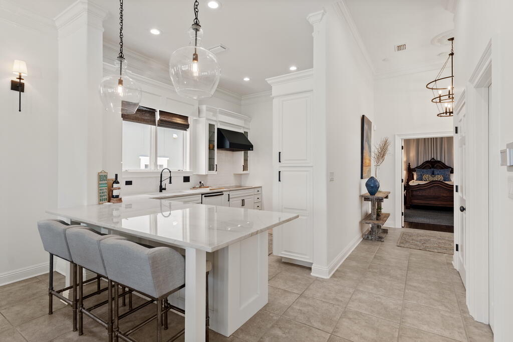 4748 Ocean Boulevard Destin, FL 32541 - Photo 28 of 80 a kitchen with stainless steel appliances kitchen island granite countertop a sink and a refrigerator