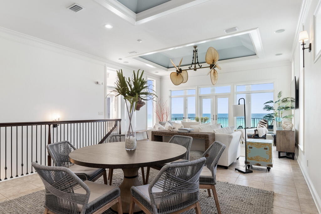 4748 Ocean Boulevard Destin, FL 32541 - Photo 41 of 80 a dining room with furniture a rug and a potted plant