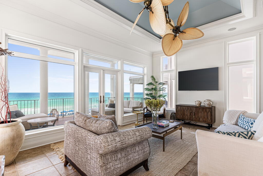 4748 Ocean Boulevard Destin, FL 32541 - Photo 46 of 80 a living room with furniture a flat screen tv and a large window