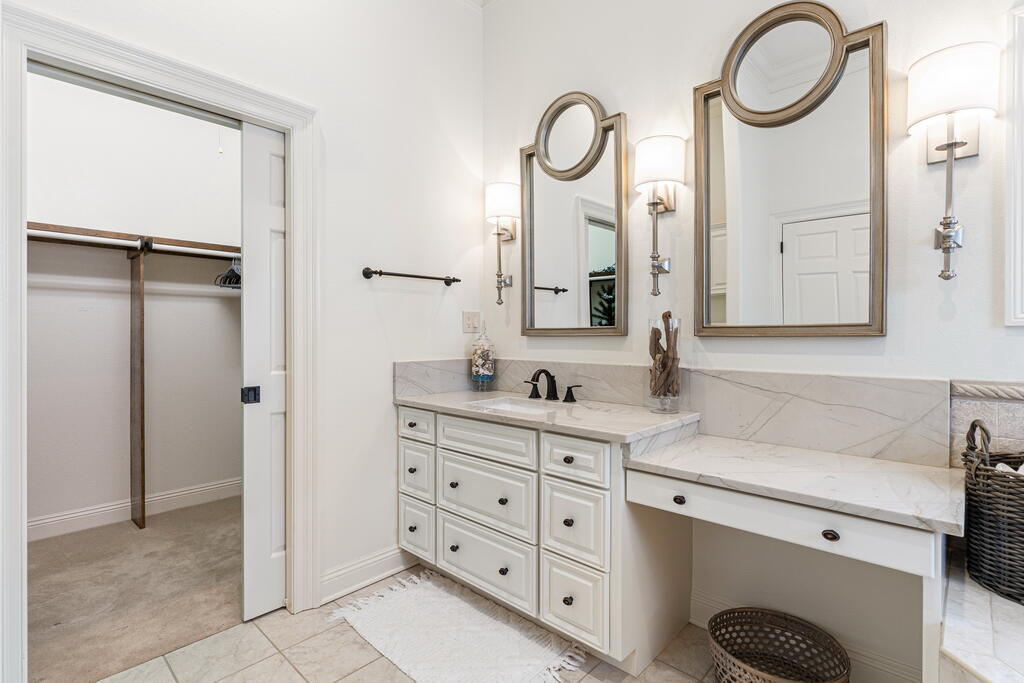 4748 Ocean Boulevard Destin, FL 32541 - Photo 53 of 80 a spacious bathroom with a granite countertop sink and a mirror