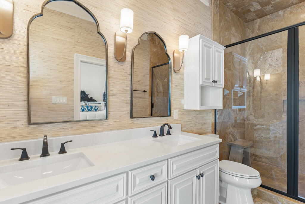 4748 Ocean Boulevard Destin, FL 32541 - Photo 61 of 80 a bathroom with a granite countertop sink a toilet and a mirror