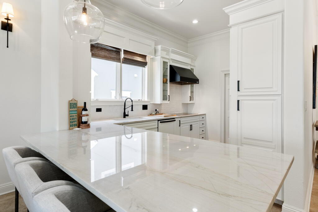 4748 Ocean Boulevard Destin, FL 32541 - Photo 9 of 80 a large white kitchen with sink and white cabinets