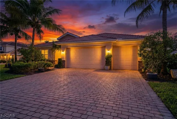 a front view of a house with a yard and a garage