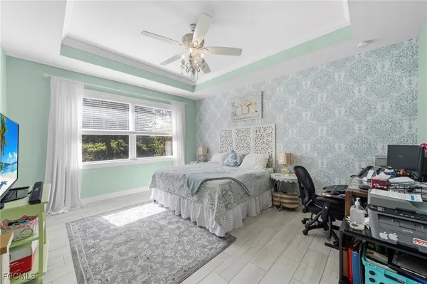 a bedroom with a bed and a chandelier