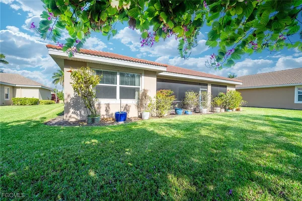 a view of a house with backyard sitting area and garden