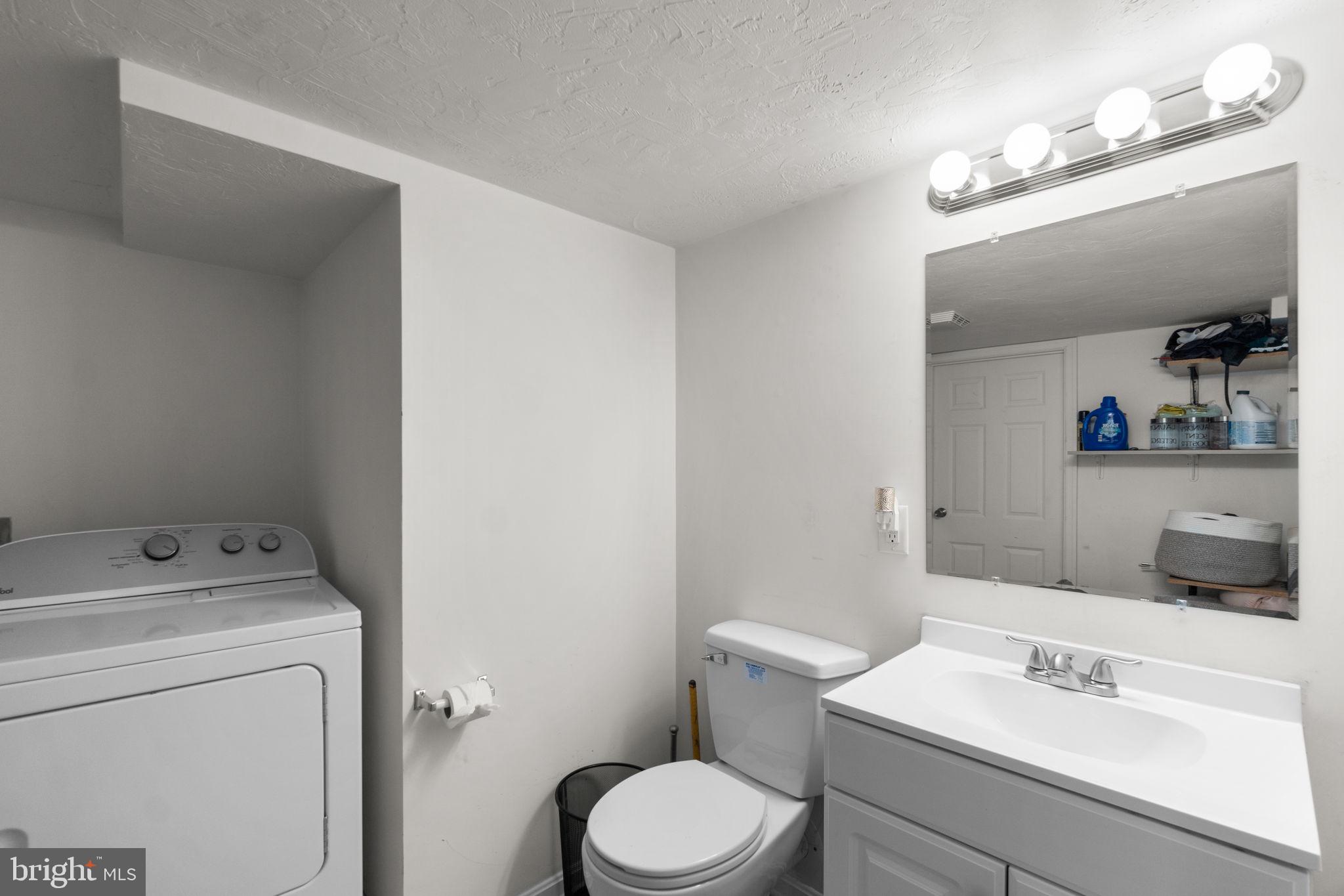 1272 Cherrytown Road Westminster, MD 21158 - Photo 22 of 30 a white toilet sitting next to a bathroom sink