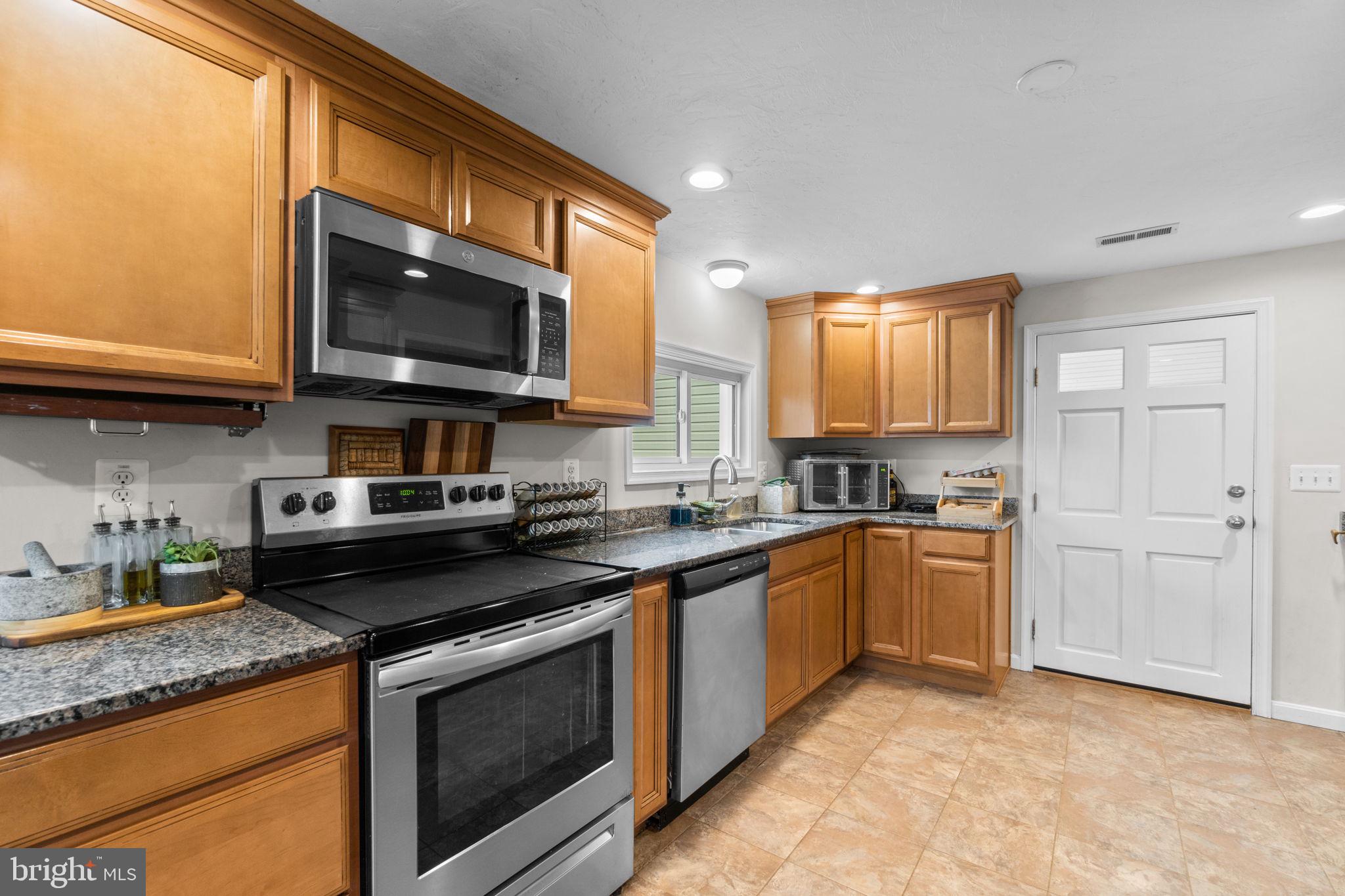 1272 Cherrytown Road Westminster, MD 21158 - Photo 9 of 30 a kitchen with stainless steel appliances granite countertop a stove microwave and sink