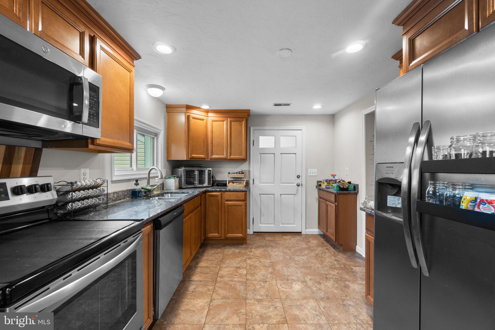 1272 Cherrytown Road Westminster, MD 21158 - Photo 10 of 30 a kitchen with stainless steel appliances granite countertop a sink stove and refrigerator