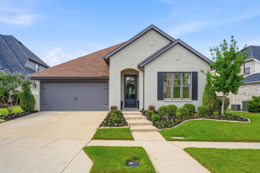 1632 Cotton Road Van Alstyne, TX 75495 - Photo 1 of 40 a front view of a house with a yard and garage
