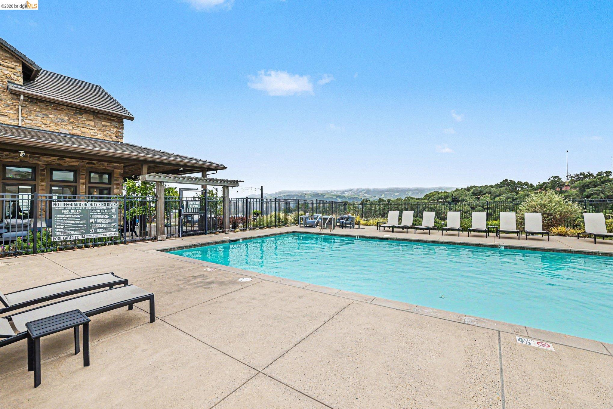 18210 Argento Loop San Ramon, CA 94583 - Photo 34 of 44 Outdoor swimming pool with concrete decking and perimeter fencing