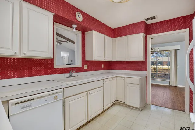 a kitchen with a stove a sink and a refrigerator