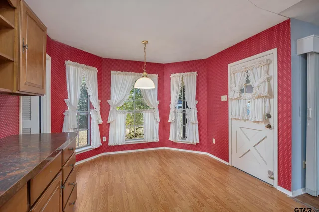 a view of a bedroom with furniture and a large window