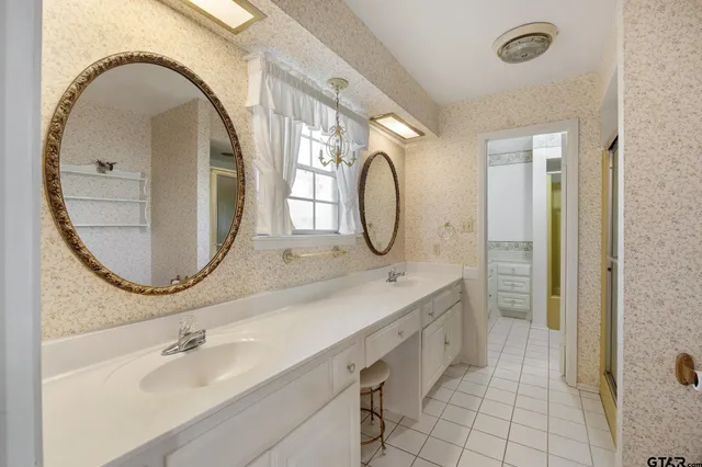 a view of an empty room with window and cabinet