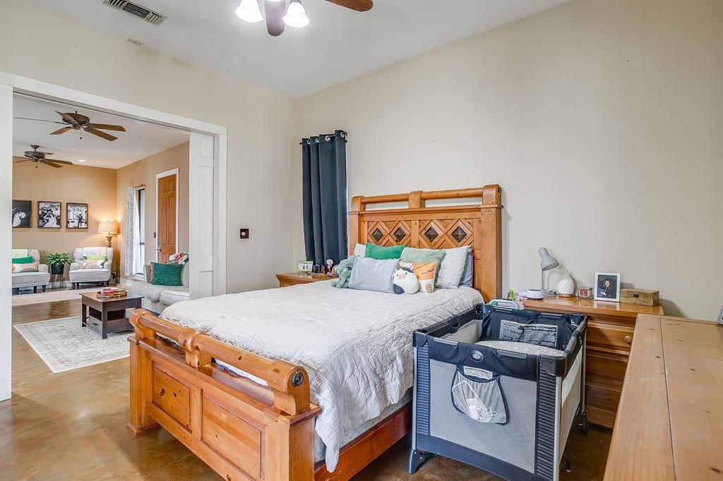 4200 Farm To Market 920 Weatherford, TX 76088 - Photo 13 of 40 a bedroom with a bed and wooden floor
