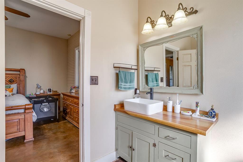 4200 Farm To Market 920 Weatherford, TX 76088 - Photo 14 of 40 a en suite bathroom with a double vanity sink and a mirror