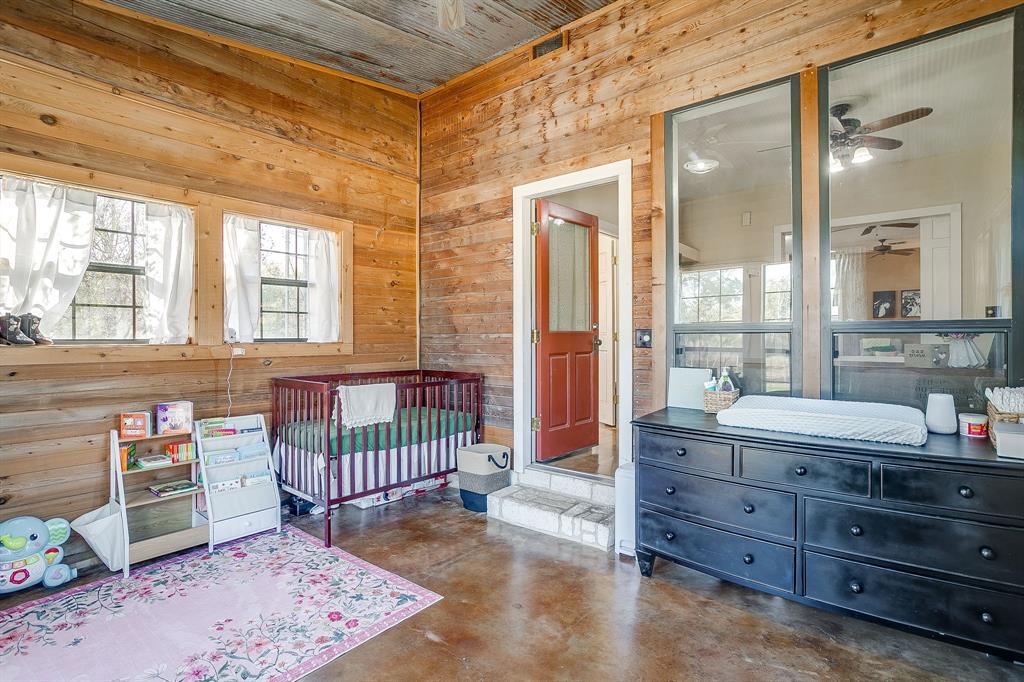 4200 Farm To Market 920 Weatherford, TX 76088 - Photo 17 of 40 a spacious bedroom with a bed and a table in it