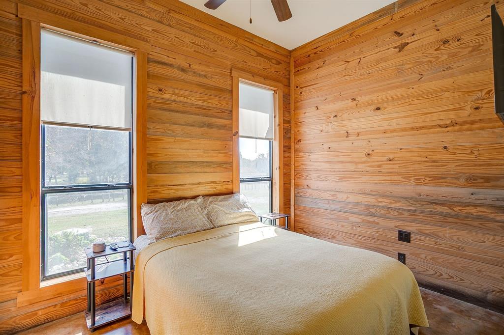 4200 Farm To Market 920 Weatherford, TX 76088 - Photo 20 of 40 a bedroom with a bed and wooden floor