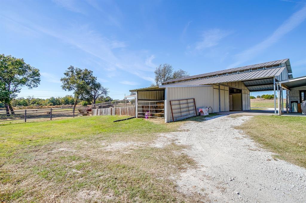 4200 Farm To Market 920 Weatherford, TX 76088 - Photo 30 of 40 a view of a house with a backyard and a garden