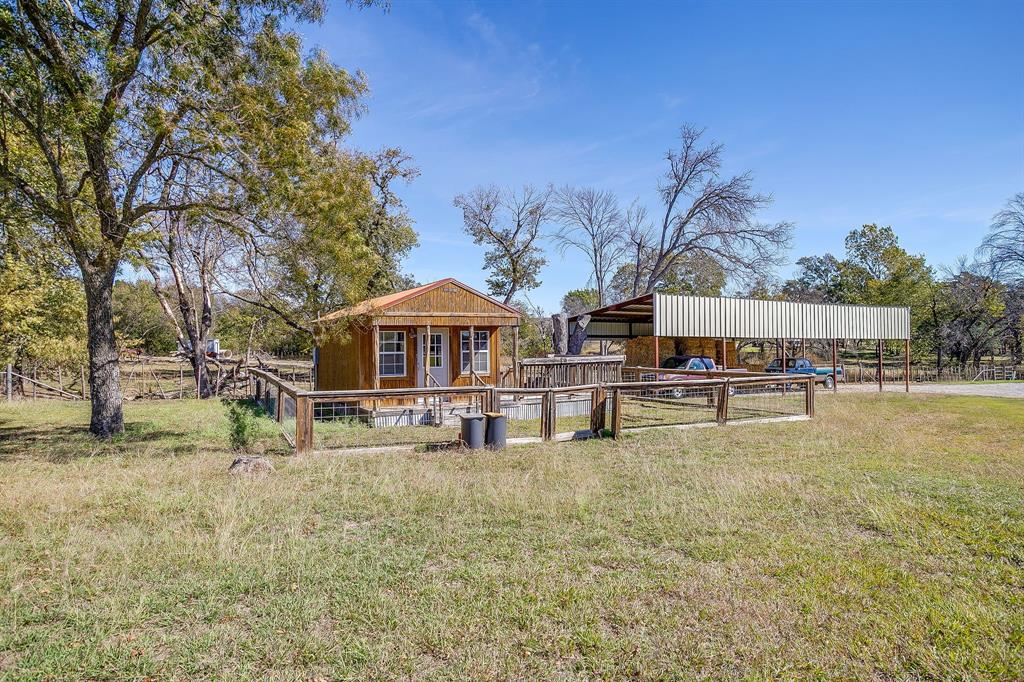 4200 Farm To Market 920 Weatherford, TX 76088 - Photo 31 of 40 a swimming pool view with large trees and a big yard