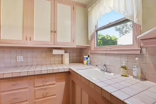 a kitchen with stainless steel appliances granite countertop a sink and a white cabinets