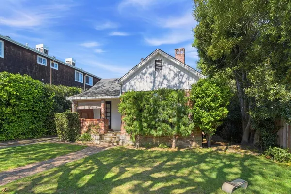 a front view of a house with a garden