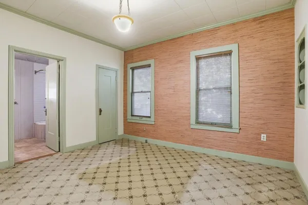 a view of a hallway with wooden floor and a livingroom