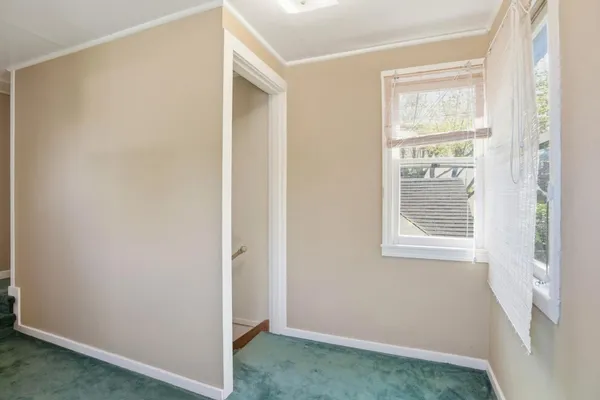a view of an empty room with windows