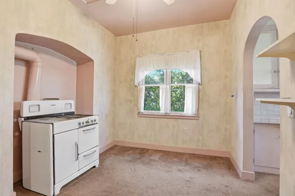 a view of a kitchen with furniture and a window