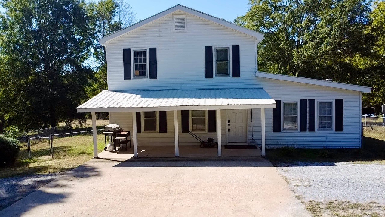 a front view of a house with yard and porch
