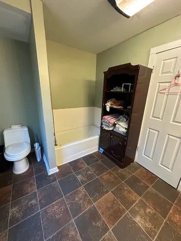 a bathroom with a toilet and a shower