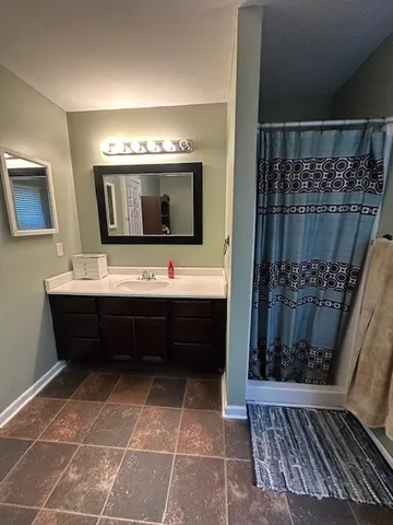 a bathroom with a double vanity sink and a mirror