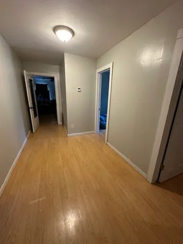 a view of an empty room and wooden floor