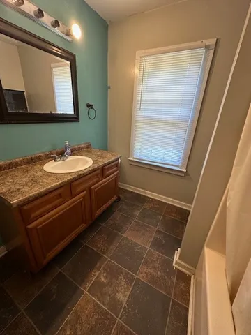a bathroom with a sink and a mirror