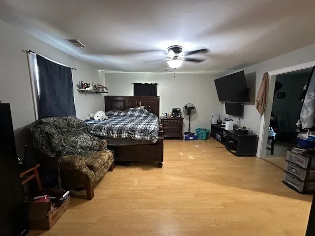 a bedroom with furniture and a flat screen tv