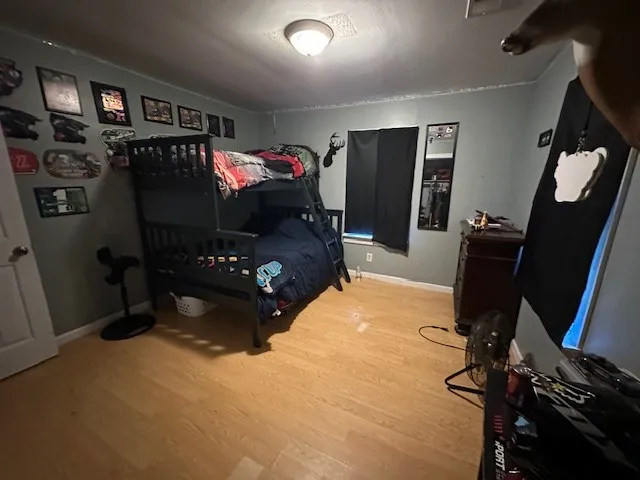 a bedroom with furniture and a flat screen tv