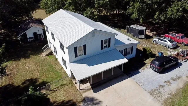 a view of a patio with table and chairs with wooden fence