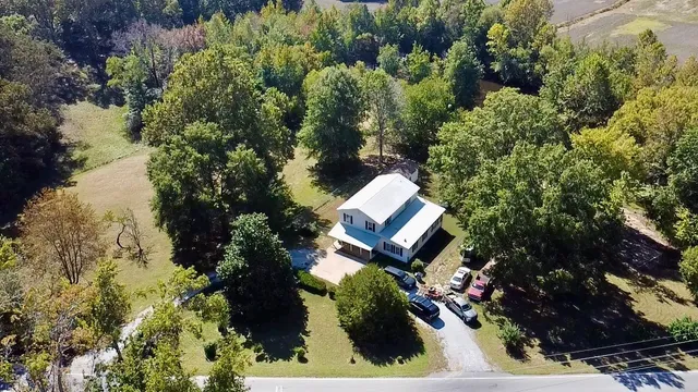 view of a house with a yard and sitting area