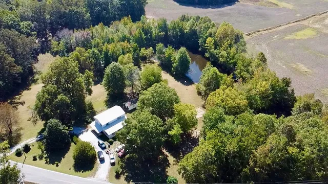 an aerial view of a house with a yard and garden