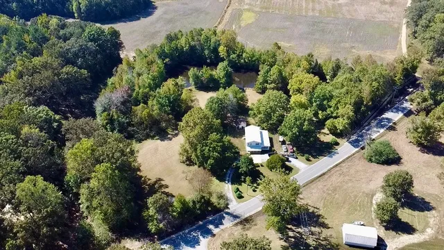 an aerial view of a house with a yard
